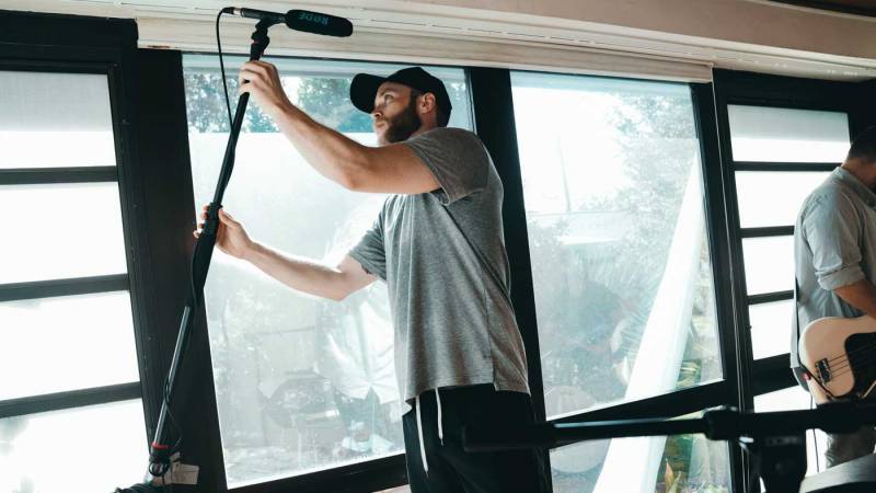 Director setting up microphone.