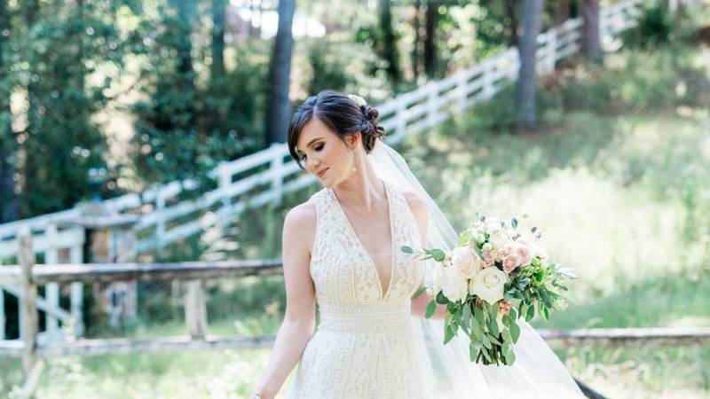 Bride standing outside in shade.