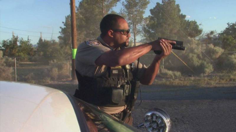 Policeman with drawn gun