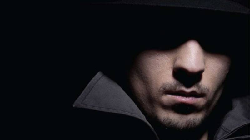 Image of a mans face in the dark with lighting that only shows bottom half of face.