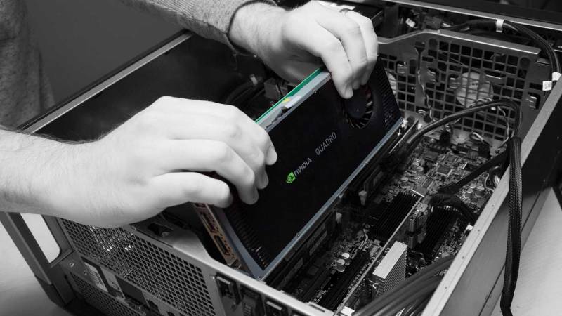 A person seating a video card in a computer.