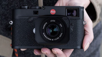 A hand holding a Leica M10