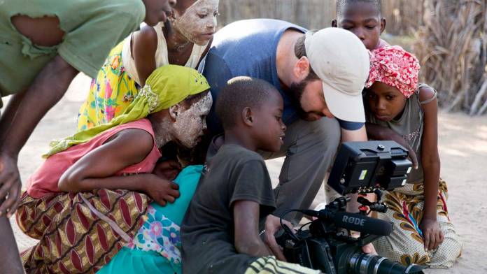 AJA-primary Cameraman shooting with children looking at viewfinder