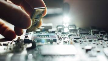 The best PC components for your custom video editing computer — 2019 Hand placing a computer component on a motherboard