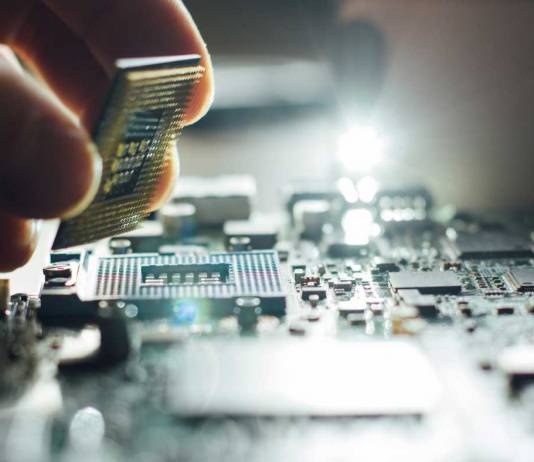 Hand placing a computer component on a motherboard