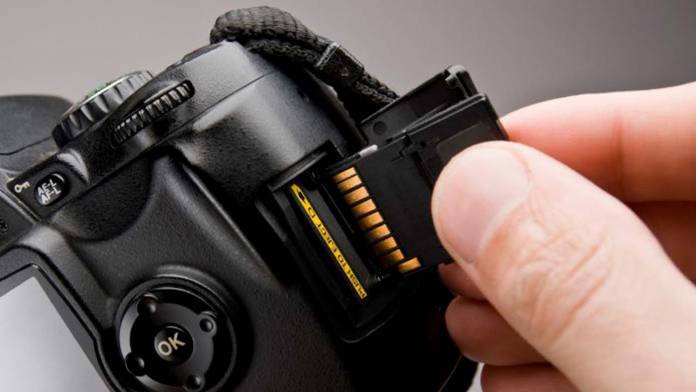 Camera-and-SD-card-696x392 Memory card being inserted into a camera