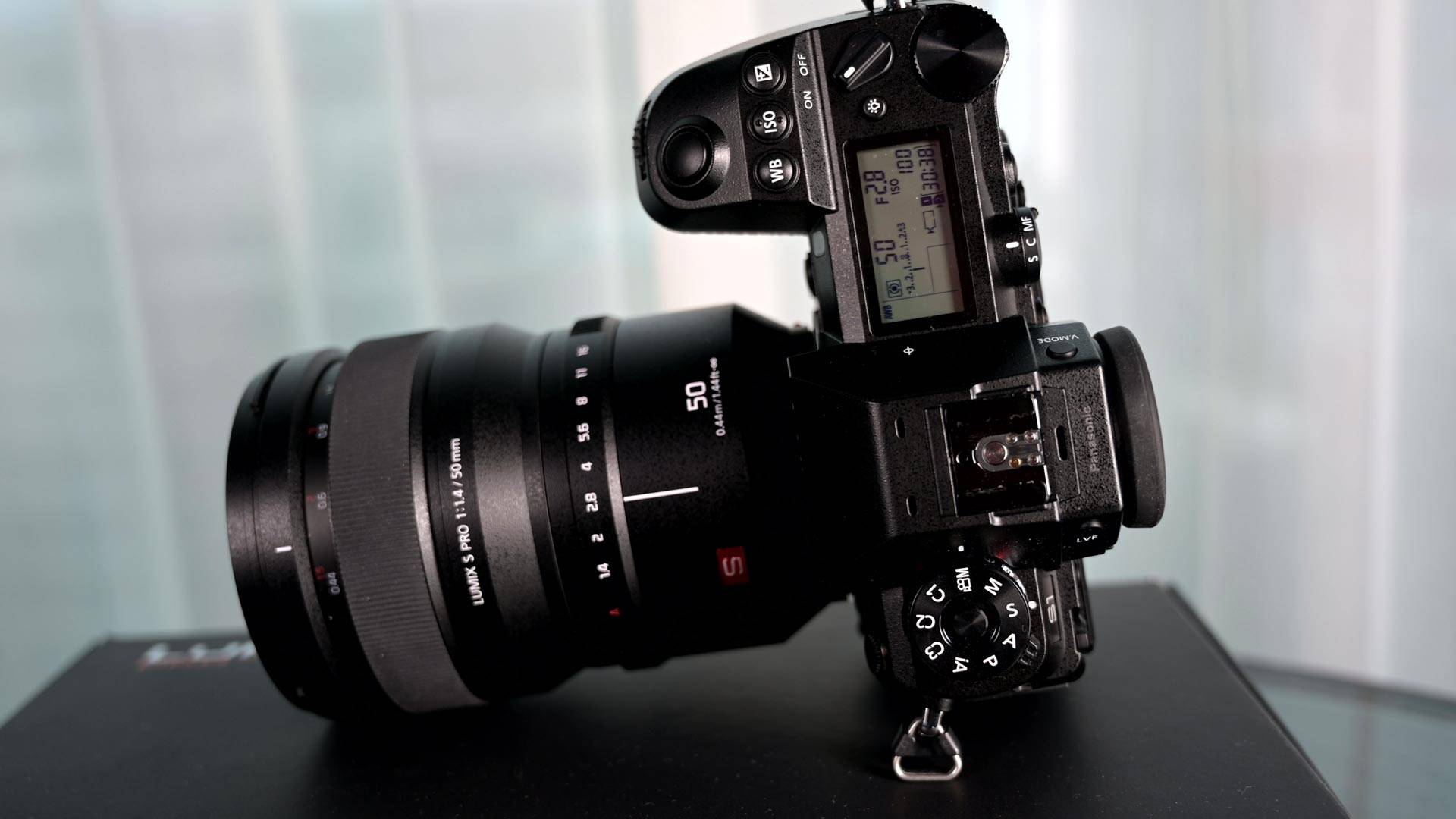 Pansonic Lumix S1 review - camera tilted to show top panel and controls