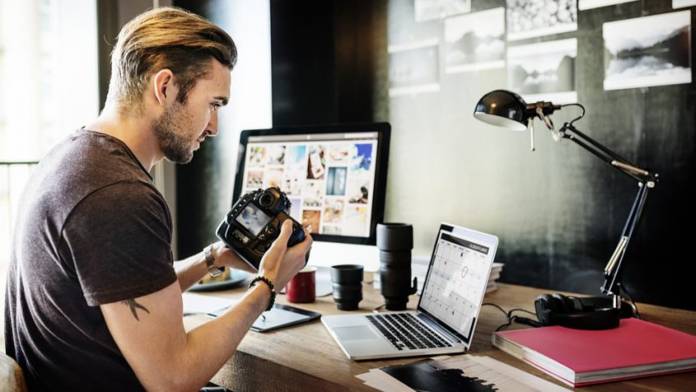 shutterstock_445094317-850x476 Man working on computer and laptop holding camera