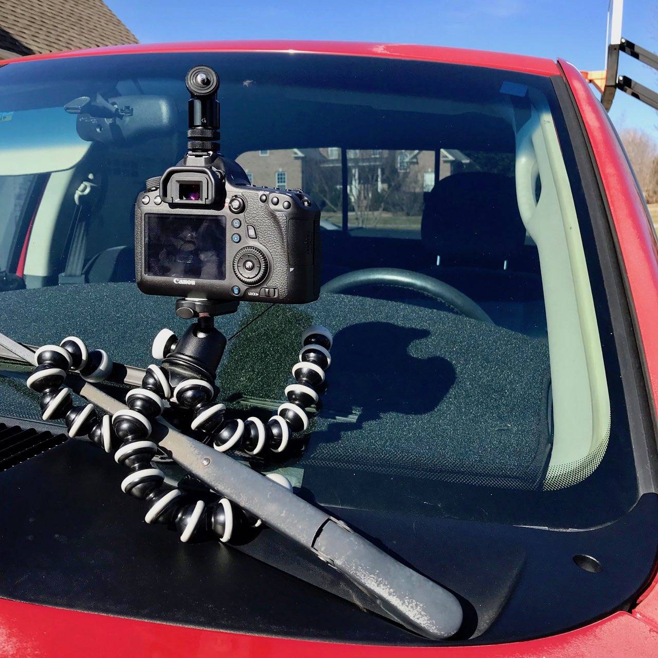 GorillaPod wrapped around vehicle's windshield wiper.