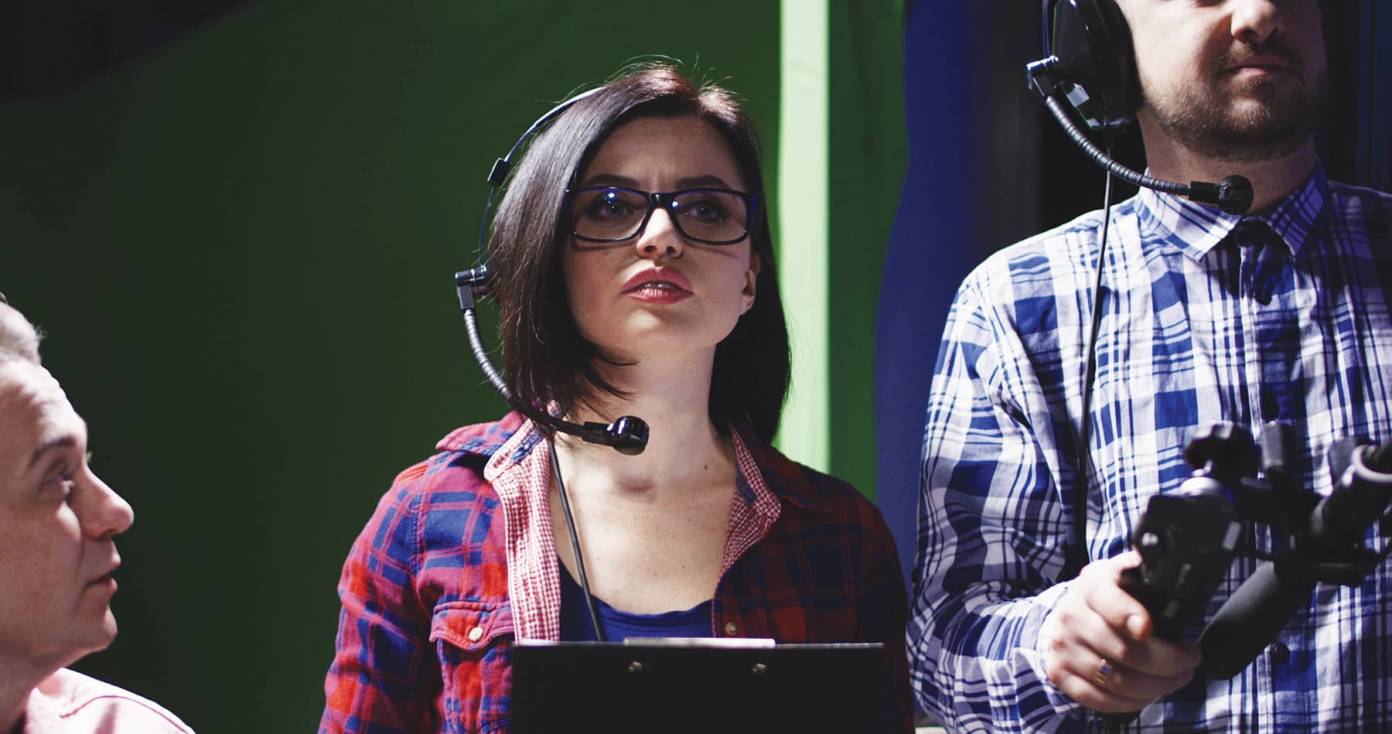 Assistant director with headset and clipboard