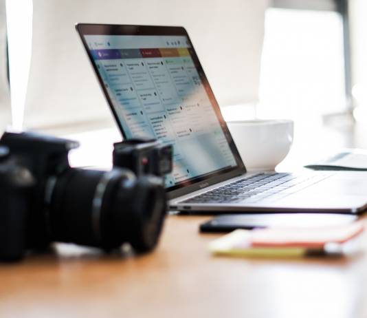 Cheapest live streaming setup for home professionals camera in the foreground with a computer behind it