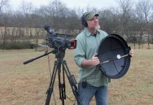 How to Build a Parabolic Microphone Dish Shot of videographer holding a DIY parabolic mic dish, standing next to a camcorder on a tripod.
