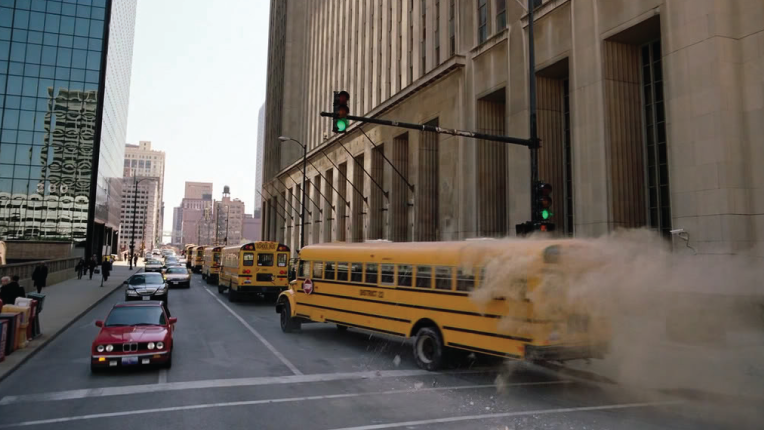 Scene from the Dark Knight - school bus full of gangsters in line of school buses.