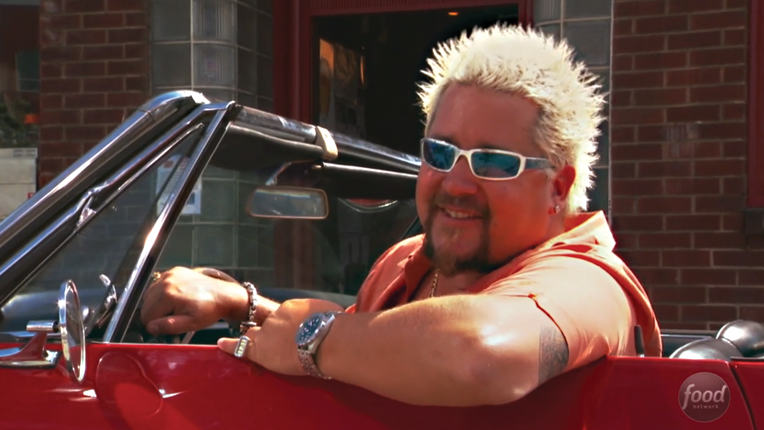 Guy in his signature red convertable.