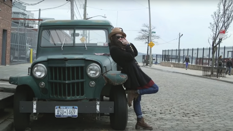 Katharine Marion, playing a harmonica solo at the faded green truck that seemed permanently parked on a cobblestone street.