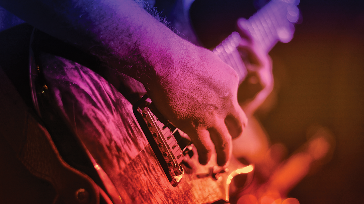 Close-up of hands playing guitar