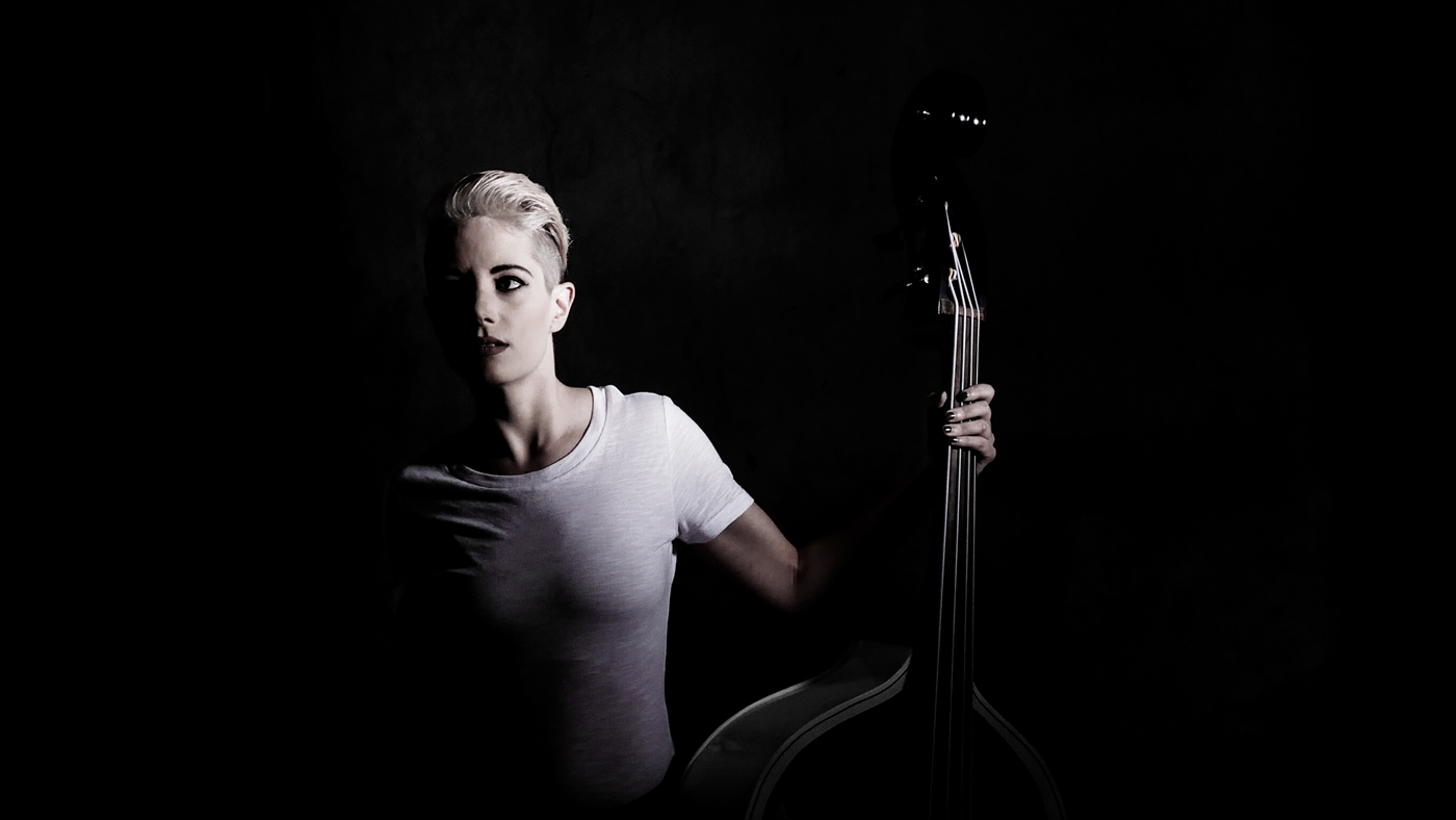 Crop from a portrait of bass player Eliza Rector that uses hard light. I lit this image with a small light positioned across the room that I snooted to make it even harder.